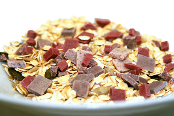 White chocolate pieces with purple fruit and vegetable powders 